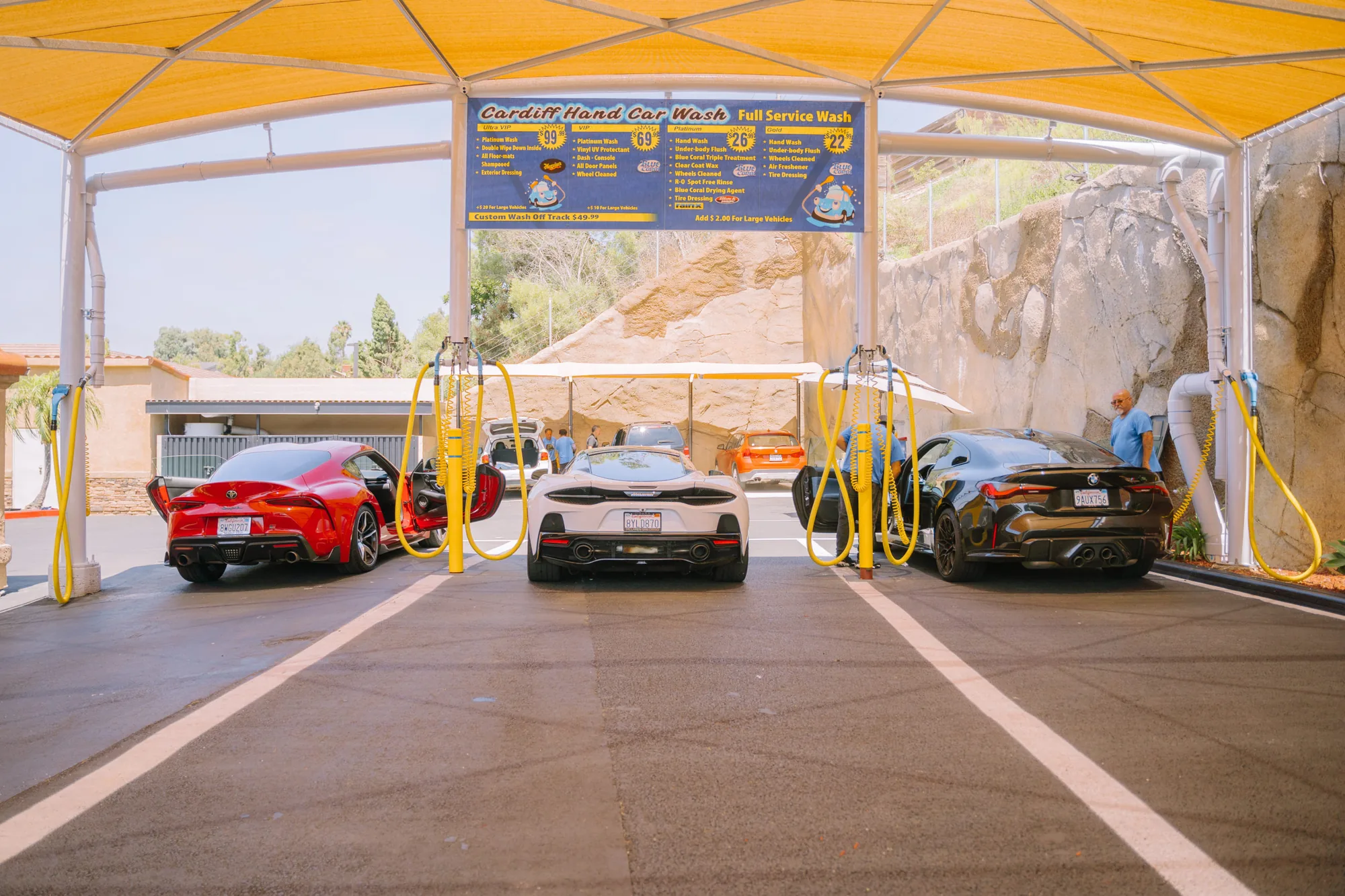 Cardiff Car Wash canopy with multiple cars being hand-washed